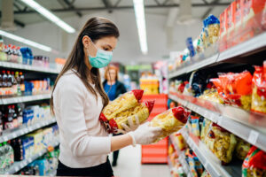 Lady checking the date code on flexible package